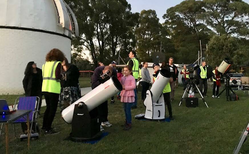 Committee members show youth how to look at the stars at the Mount Burnett Observatory in Victoria. Picture supplied. 