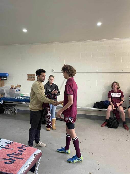 Marcus Mundy and Lucinda Thurston hand out the new Indigenous jerseys to the Tathra Rugby League Juniors club's under 14 and under 16 players. Picture supplied. 