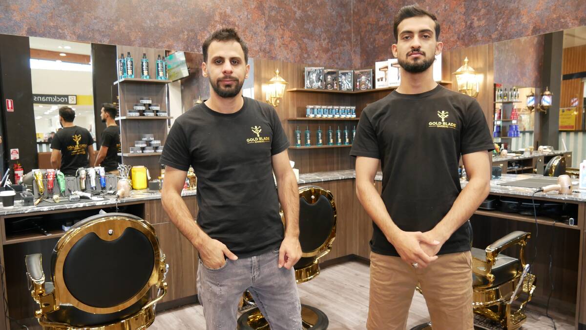The interior of the barber shop has been fitted out with high quality barber chairs, styling equipment, and other specialised trade tools. Here Ammar Jashami (right) stands in the flash new shop next to his employee Sam Al-Khamees. Photo: Ellouise Bailey 