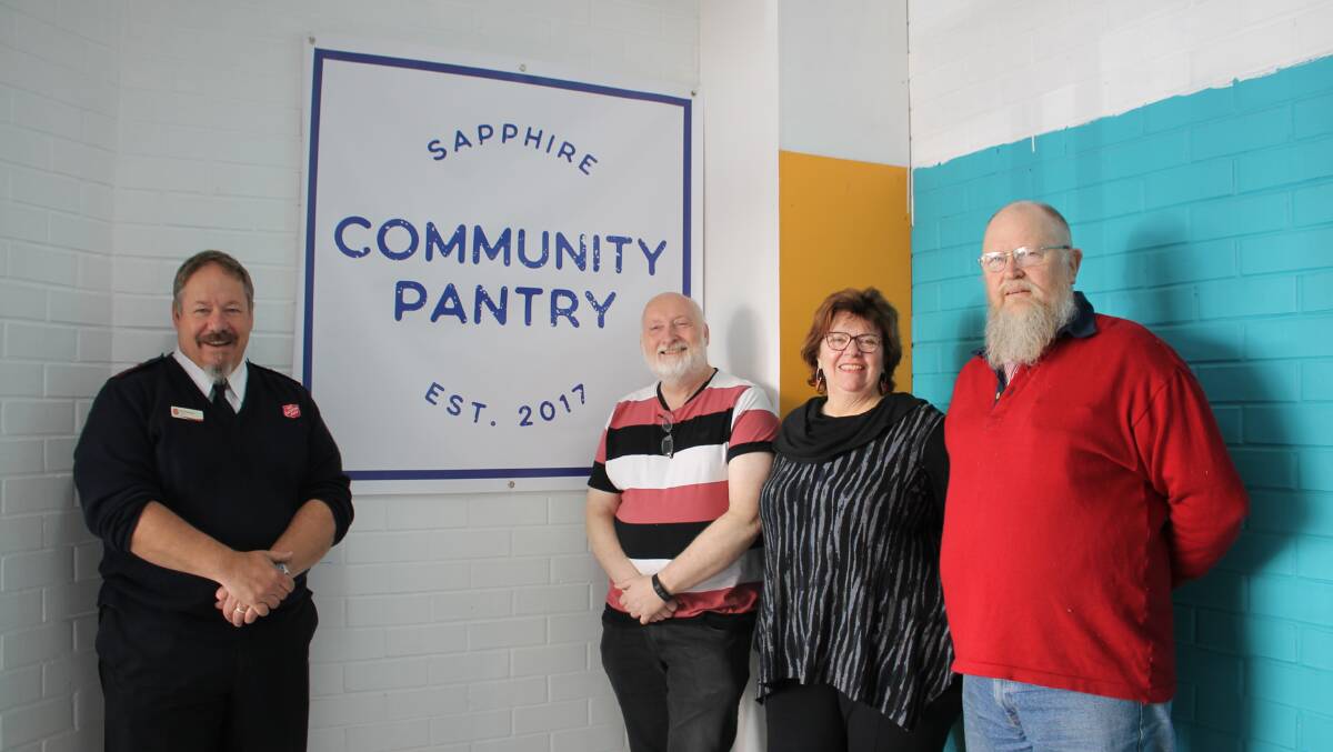 Rod Parsons of Bega's Salvation Army at the pantry's first shop site in August 2017 with pantry committee members Peter Buggy and Christine Welsh, and Family Store manager John Horsburgh. Picture by Alana Beitz