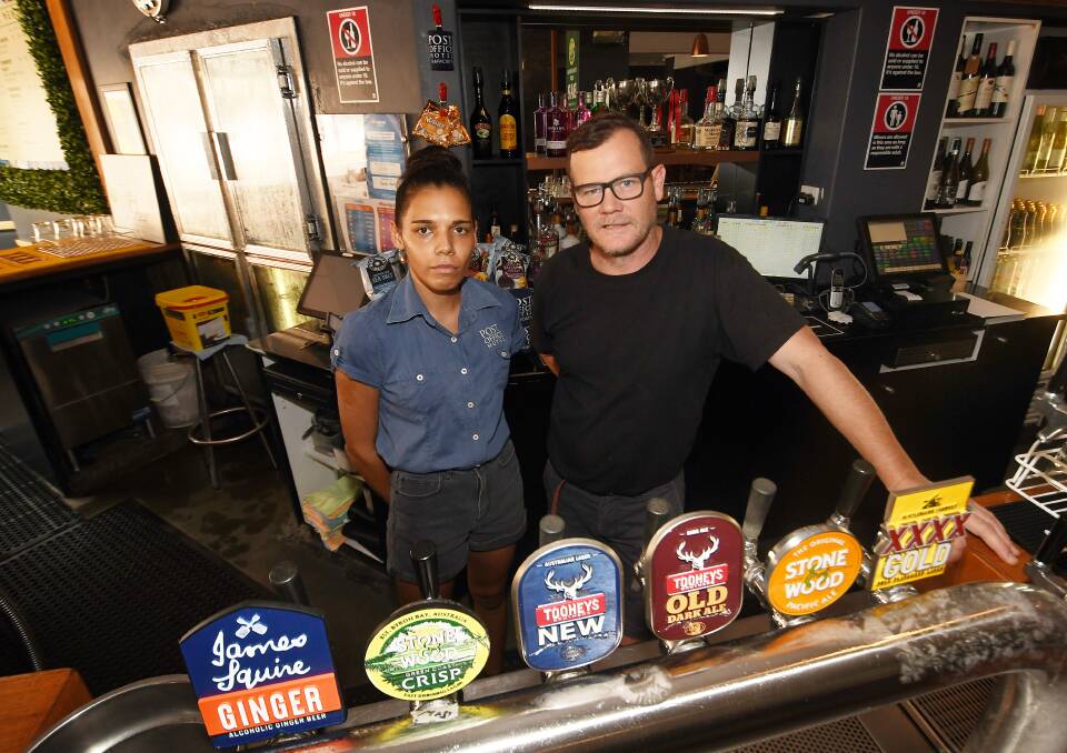 Bar attendant Lara Knox and licensee Andrew Coutts behind the bar at the Post Office Hotel. Picture by Gareth Gardner