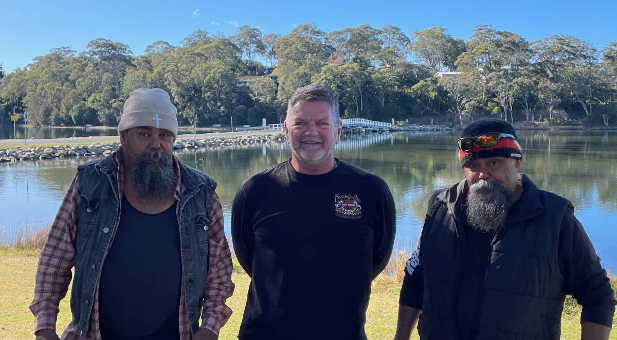 Gordon Patterson (centre), president of the Bermagui Area Chamber of Commerce and Tourism, wants a new bridge built to fire-proof and flood-proof the bridge and the community who rely on it. Picture by Marion Williams.