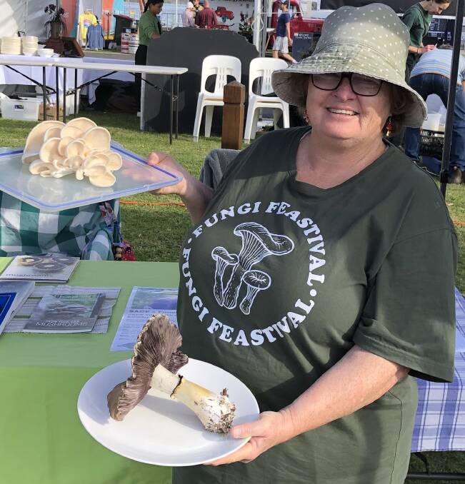 Annette Kennewell at Fungi Feastival stall at Narooma Oyster Festival on Saturday, May 6, holding white oyster mushrooms and a wine cap mushroom. Picture supplied.