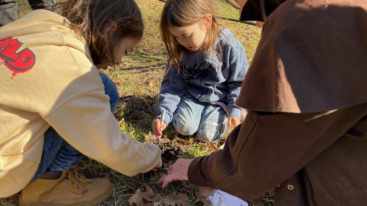 People of all ages enjoy the fun of watching the truffle dog find the truffles at Gulaga Gold, putting their nose to the ground to pinpoint the spot and then carefully extracting the truffles using a spoon. Picture by Marion Williams