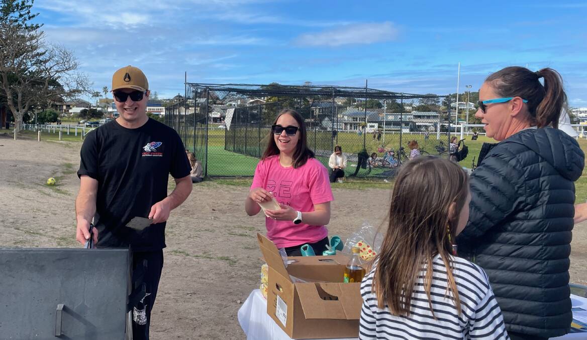 On their day off, Zak and Carla of Bermagui Fresh Food Emporium put on a sausage sizzle for the open day for Bermagui's new netball and basketball courts. Picture by Marion Williams