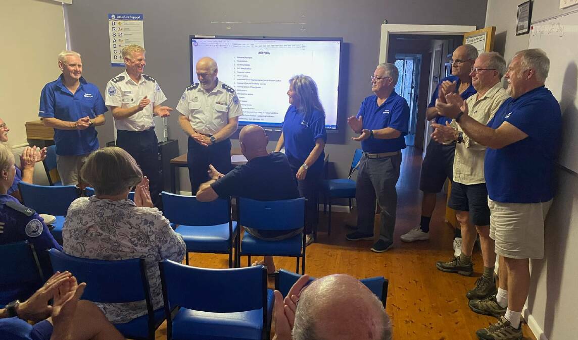 The executive of Marine Rescue Narooma presents Unit Commander John Lundy with his five-year service pin. Picture supplied