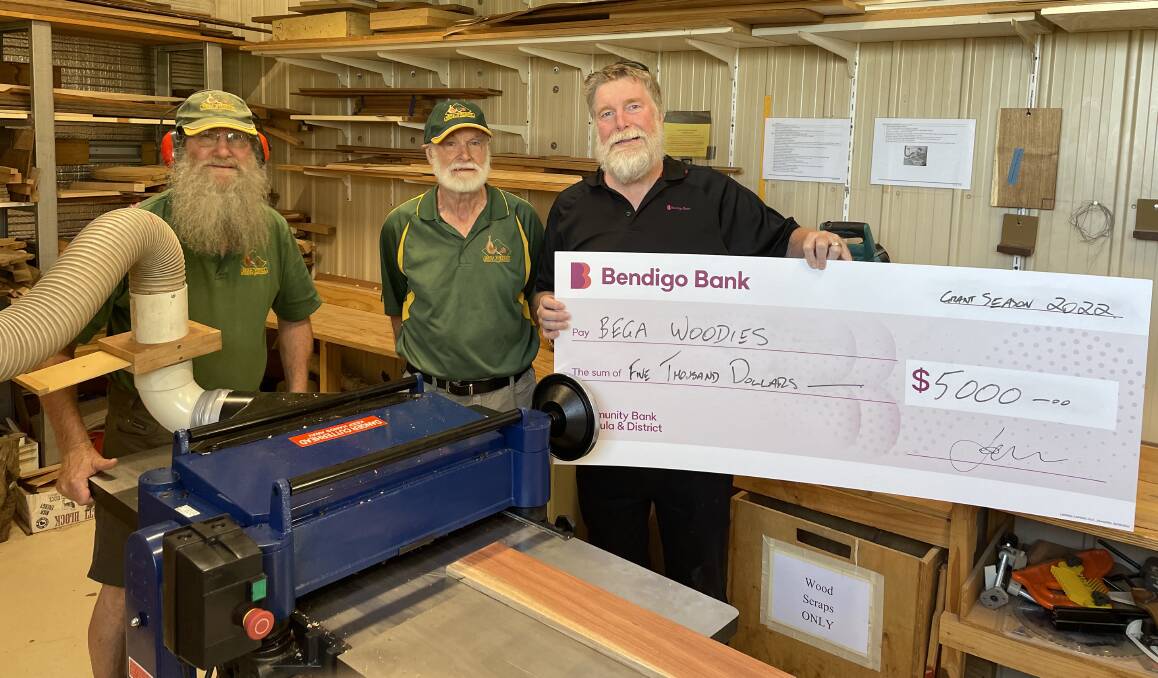The Bega Woodies' Vice President Don Firth, Secretary Richard Kleine with Bendigo Bank's Graham Stubbs and their newly purchased thicknesser. Picture by Sam Armes. 