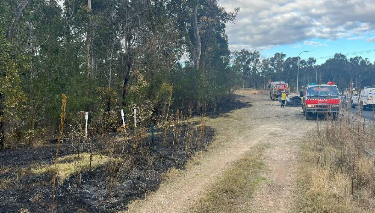 The RFS brigade in Batemans Bay extinguished a bush fire on August 31 which had spread from a torched car on Heron Road in Catalina. Picture via NSW RFS - Batemans Bay Brigade/Facebook