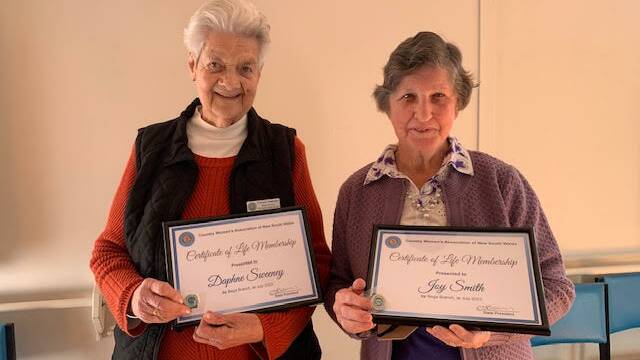 Daphne Sweeney and Joy Smith with their life membership certificates and badges. Picture supplied.