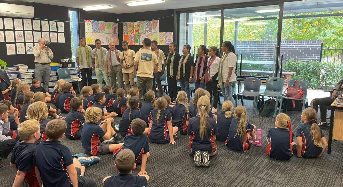 Year 3 and 4 students at Lumen Christi watch the choir perform an encore. Picture by James Parker