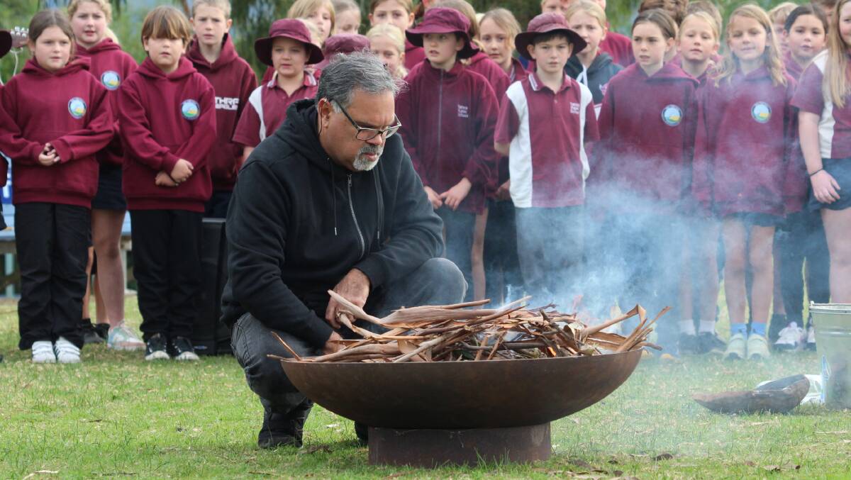 Djiringanj Elder David Dixon prepared the smoking ceremony while students performed 'From Little Things Big Things Grow.' Picture by James Parker