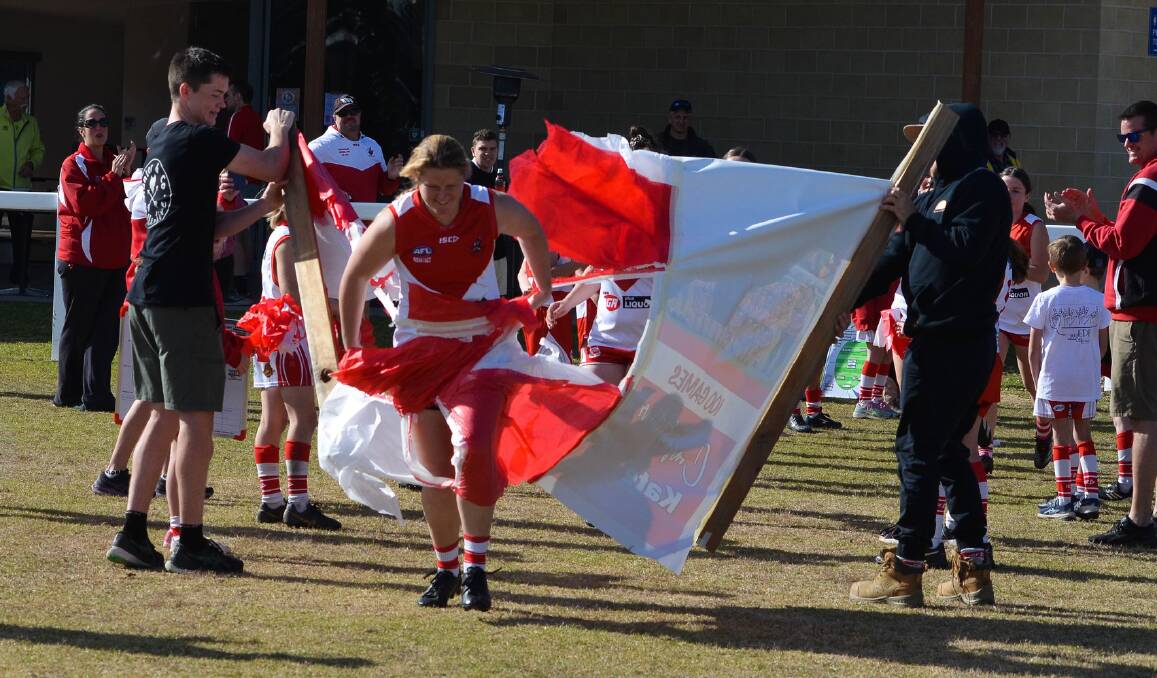 Eden Whalers captain Kate Mitchell leads her team on to the field on Saturday for her 100th senior game in the SCAFL competition. Picture supplied