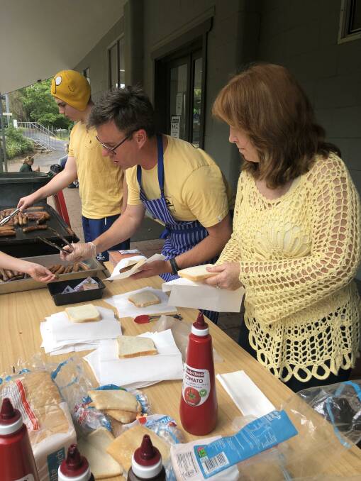 Max Stylianou, Jay Trevaskis and Lynda Whyman run a sausage sizzle raising funds for Ukraine families.