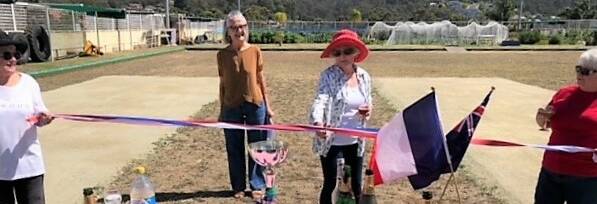 Gabriel Roberts cuts the ribbon for the inauguration of the Clive Roberts Memorial Pétanque Piste area, as a tribute to her recently deceased husband who was a long-serving club and committee member. Picture supplied