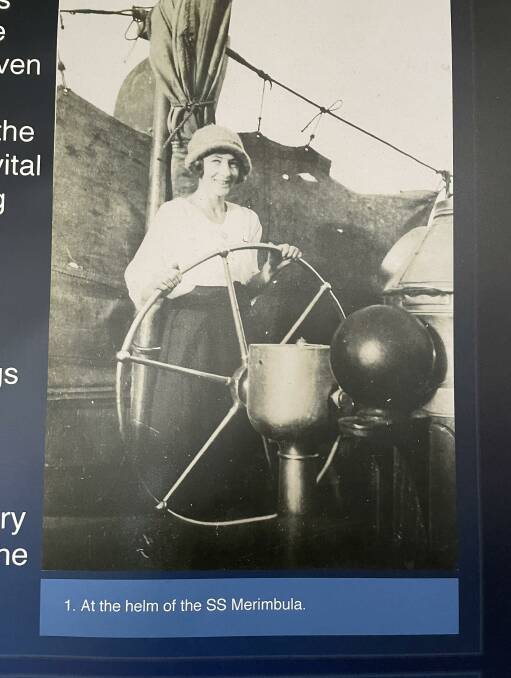Gladys Arnold at the helm of SS Merimbula while docked at Tathra Wharf. 