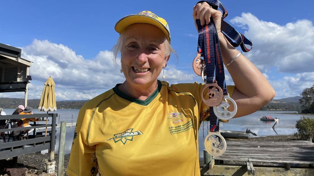 Gill McCallum at Merimbula's Top Lake with her medals from the World Dragon Boat Championships, Thailand. Picture by Denise Dion