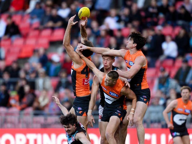 Sam Taylor (right) was injured during the Giants' win over Port Adelaide in Sydney. (Steven Markham/AAP PHOTOS)